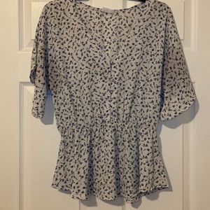 White blouse with cinched waist and button detail